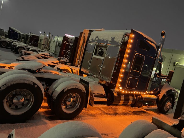 Flatbed truck in snow at night