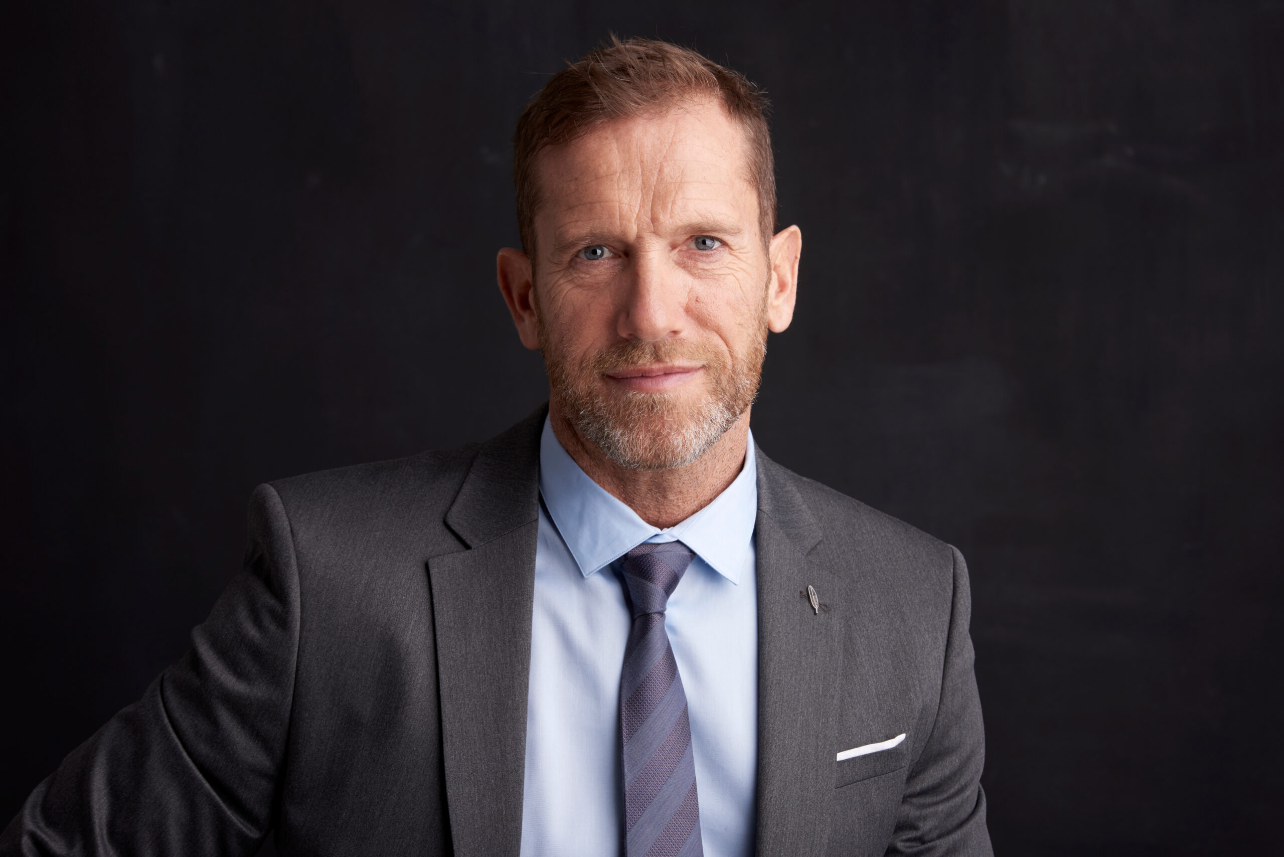 Portrait Shot of a Smiling Middle Aged Businessman Wearing Suit